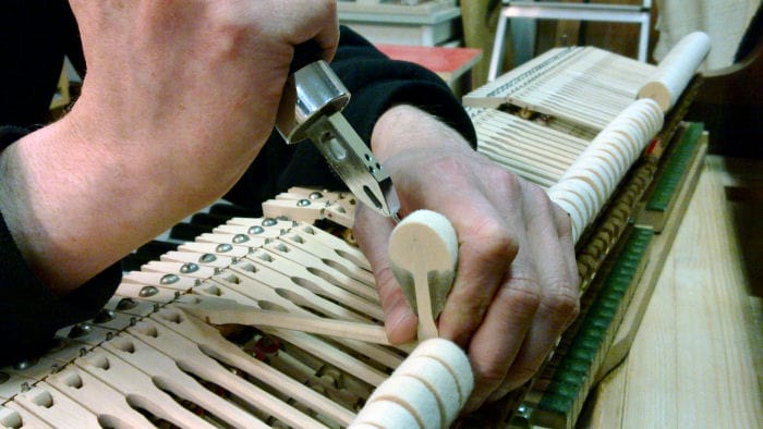 Flyygelin koneisto. Vasaroiden intonointi eli pehmennys työkalulla jossa on intonointi neulat